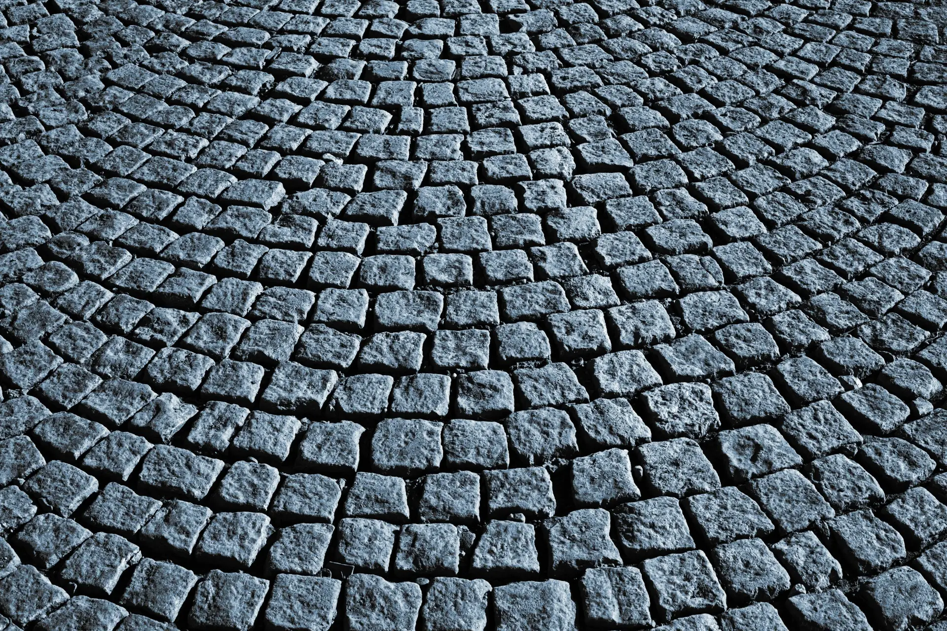 Circular cobblestone pattern on a street in Rijeka, Croatia, showcasing texture.